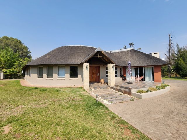 Thatched roof 4-bedroom house with a flatlet on the big yard.